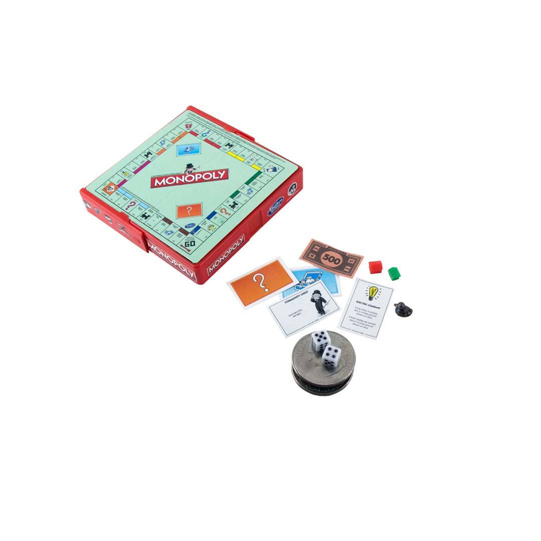 World's Smallest Monopoly travel-sized board game with miniature pieces and cards