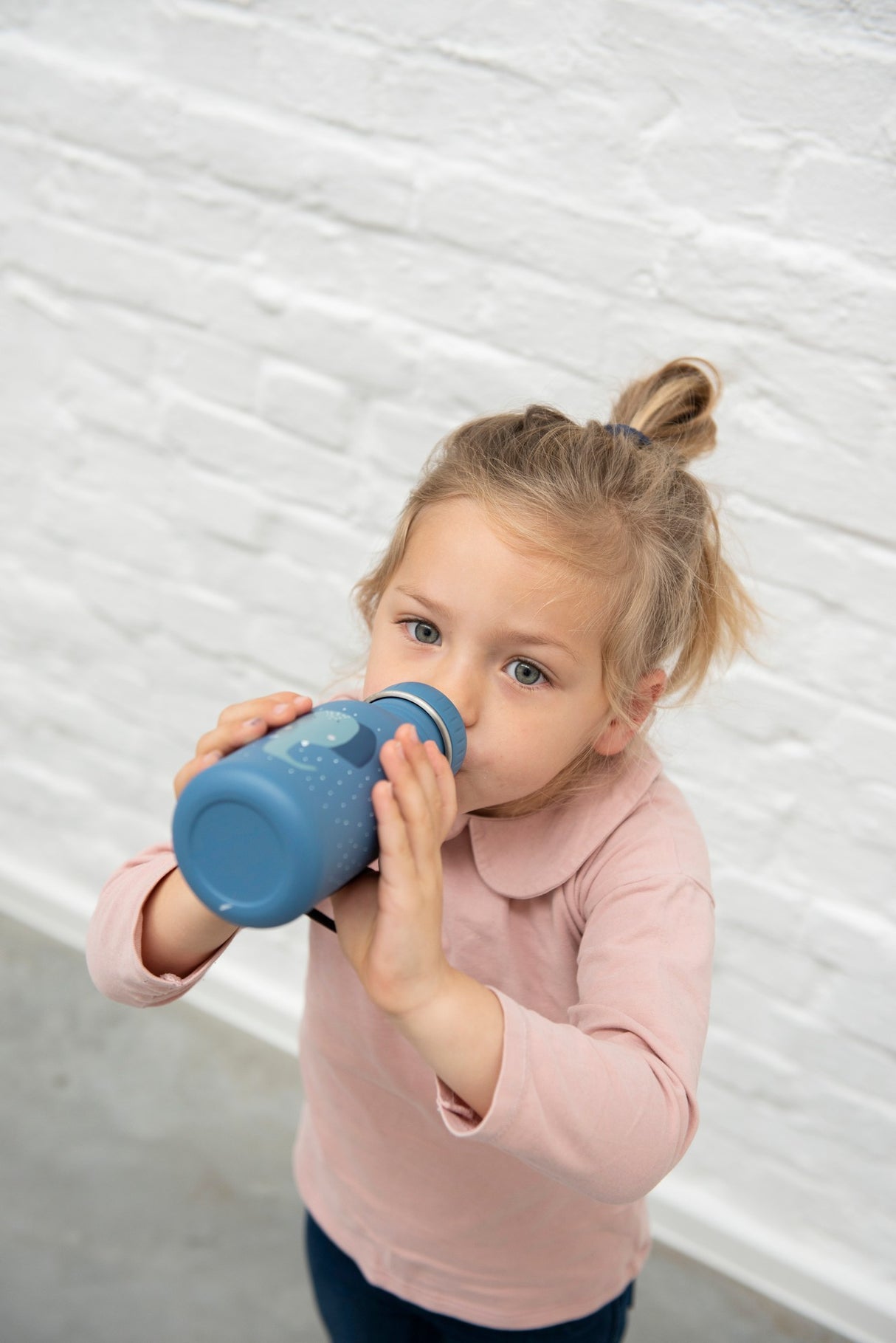 a little girl that is brushing her teeth 